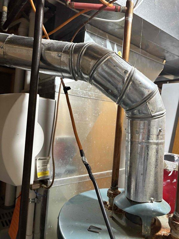 Completed Furnace Super Tune-up and water heater tune-up for daycare facility inspection documentation. Both units are aged systems showing significant wear, with visible rust accumulation on water heater connections and dust buildup on ductwork. All required maintenance procedures performed and documented to meet daycare inspection requirements.