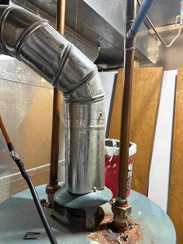 Completed Furnace Super Tune-up and water heater tune-up for daycare facility inspection documentation. Both units are aged systems showing significant wear, with visible rust accumulation on water heater connections and dust buildup on ductwork. All required maintenance procedures performed and documented to meet daycare inspection requirements.