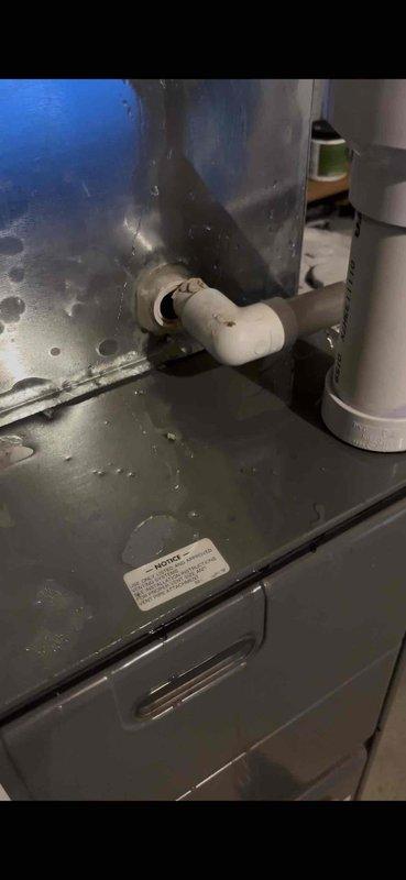 Responded to water leak caused by broken condensate drain pipe on 14-year-old Rheem HVAC unit. Upon arrival, found the white PVC condensate pipe elbow fitting had separated from the system, resulting in active water discharge onto the equipment and surrounding area. Repaired the damaged condensate drain connection, restored proper drainage function, and verified system operation. Documented existing moisture on metal panels and components due to the leak prior to repair.