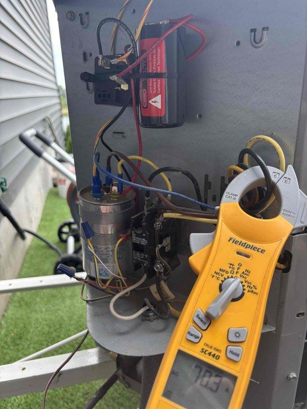 Completed annual cooling maintenance on Carrier outdoor condensing unit. Performed comprehensive system inspection including electrical testing with digital multimeter, recording amperage draw of 42.3 amps at compressor. Verified proper operation of dual-run capacitor and electrical components within disconnect panel, confirmed all wire connections secure and terminals tight. Unit operating within normal parameters with no deficiencies noted.