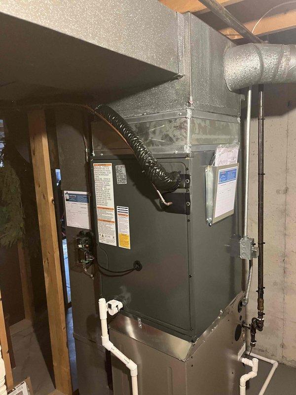 Completed full HVAC system installation including indoor furnace/air handler unit and outdoor Amana condensing unit. Installed furnace in basement utility area with proper ductwork connections, PVC condensate drainage system, and electrical conduit. Mounted outdoor condenser on concrete pad against exterior wall with appropriate clearances, connected refrigerant lines, installed electrical service disconnect, and completed PVC drainage piping through exterior wall. System tested and verified operational upon completion.