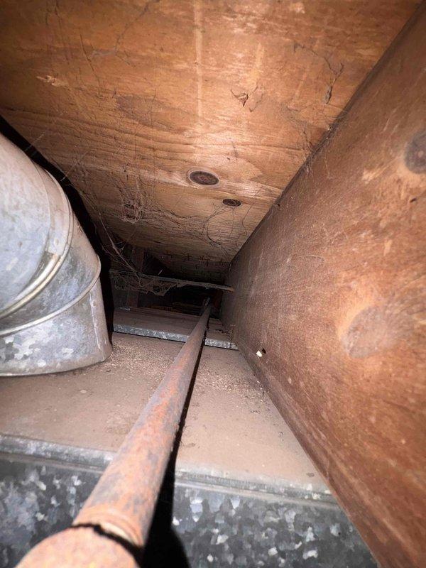 Installed new gas line from furnace location through attic crawlspace to building exterior. Routed black iron pipe through confined attic space, navigating around existing HVAC ductwork and structural framing members. Installation completed per code requirements for residential gas piping.