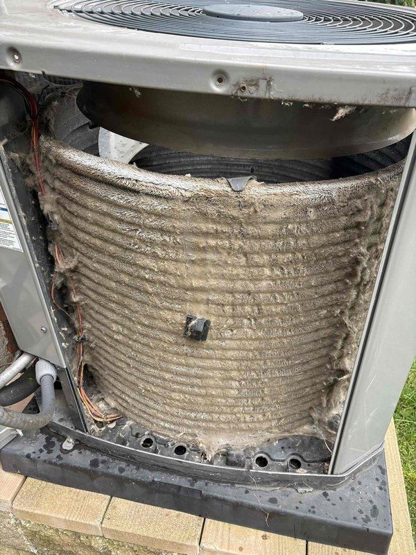 Completed annual cooling maintenance on outdoor air conditioning unit. Upon inspection, found condenser coils heavily soiled with accumulated dirt, dust, and debris throughout all surfaces, significantly restricting airflow and reducing heat transfer efficiency. Removed access panels and thoroughly cleaned condenser coils using appropriate cleaning methods to restore proper heat exchange capability. Cleared debris from unit base and surrounding area. Reinstalled access panels and verified unit operation. System restored to proper operating condition with improved airflow across coil surfaces.