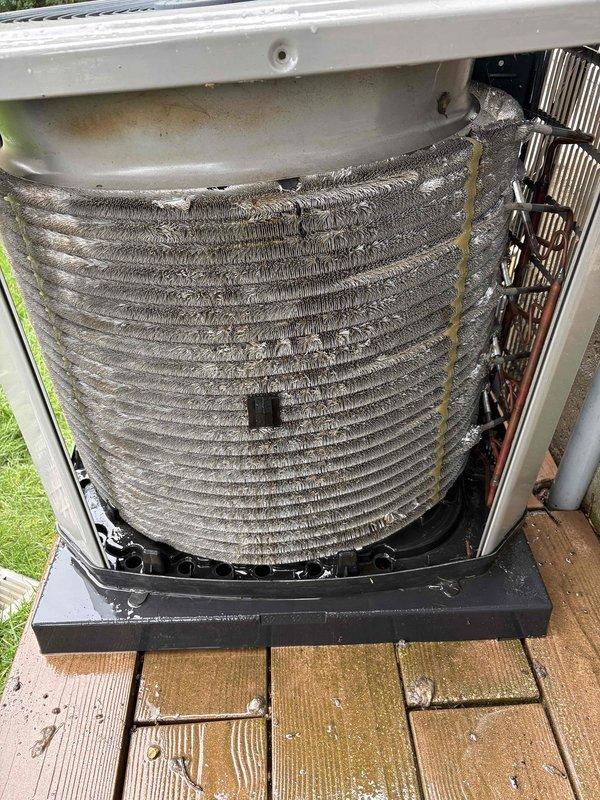 Completed annual cooling maintenance on outdoor air conditioning unit. Upon inspection, found condenser coils heavily soiled with accumulated dirt, dust, and debris throughout all surfaces, significantly restricting airflow and reducing heat transfer efficiency. Removed access panels and thoroughly cleaned condenser coils using appropriate cleaning methods to restore proper heat exchange capability. Cleared debris from unit base and surrounding area. Reinstalled access panels and verified unit operation. System restored to proper operating condition with improved airflow across coil surfaces.