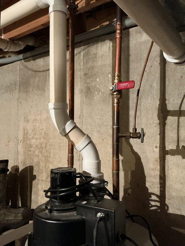 Completed estimate for standard water heater replacement in residential basement utility area. Inspected existing plumbing infrastructure including copper supply lines with shut-off valve, PVC drainage system, and sump pump installation mounted against concrete foundation wall. Documented current mechanical configuration and photographed existing conditions to provide accurate replacement specifications. No additional plumbing concerns or water heater symptoms identified during site assessment.