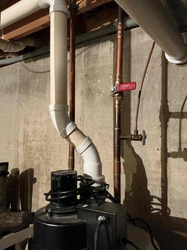 Completed estimate for standard water heater replacement in residential basement utility area. Inspected existing plumbing infrastructure including copper supply lines with shut-off valve, PVC drainage system, and sump pump installation mounted against concrete foundation wall. Documented current mechanical configuration and photographed existing conditions to provide accurate replacement specifications. No additional plumbing concerns or water heater symptoms identified during site assessment.