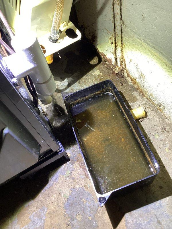 Completed annual heating and cooling maintenance on 3-year-old EnergiAir AC unit and 13-year-old EnergiAir furnace system. During inspection, identified significant moisture accumulation in condensate drain pan with standing water containing sediment and algae buildup, indicating drainage system obstruction. Observed extensive water damage and staining on basement floor and walls near HVAC equipment, suggesting chronic condensate drainage issues requiring attention. Performed standard tune-up procedures on both units including filter inspection, electrical connections check, and operational testing. Documented moisture concerns with photos for customer review and recommended condensate line cleaning and drain pan maintenance to prevent future water damage and potential equipment corrosion.