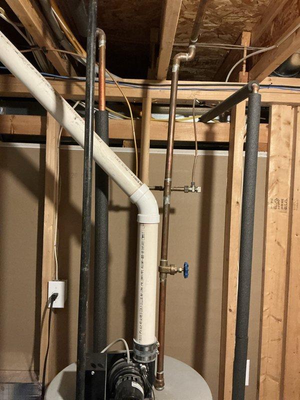 Conducted water heater replacement estimate for single-family residence with 23-year-old GSW tank-style unit showing signs of failure. Inspected existing installation in basement utility area, documented current plumbing configuration including copper supply lines, PVC venting, and drain connections. Provided comprehensive quotes for both traditional tank-style and tankless water heater replacement options per customer request.