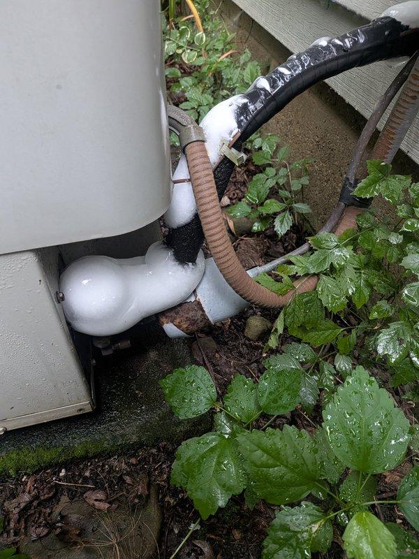 Responded to no cooling complaint on 26-year-old International Comfort Products system. Found outdoor condenser fan operational but unit not producing cool air. Inspected indoor air handler components including condensate pump and drainage system, which appeared functional. Evaluated outdoor unit installation and refrigerant line insulation at exterior wall penetration. System requires further diagnostic testing to determine root cause of cooling failure, likely involving refrigerant charge verification, compressor operation assessment, or potential airflow restrictions.