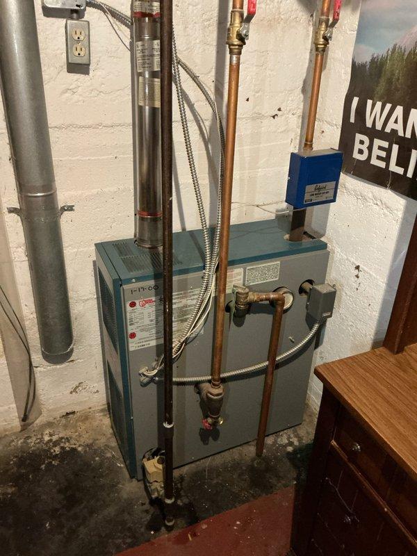 Completed annual heating and cooling maintenance on two 18-year-old Carrier systems, performing comprehensive tune-ups on air conditioning unit, furnace, and humidifier. Inspected all major components including heat exchanger, blower motor, condensate lines, electrical connections, and refrigerant levels. Observed existing water heater installation with proper copper piping connections and shut-off valves, along with basement plumbing infrastructure showing age-related corrosion on brass fittings and oxidation on copper piping. All HVAC systems tested and operating within manufacturer specifications at time of service completion. Unit covered under home warranty.