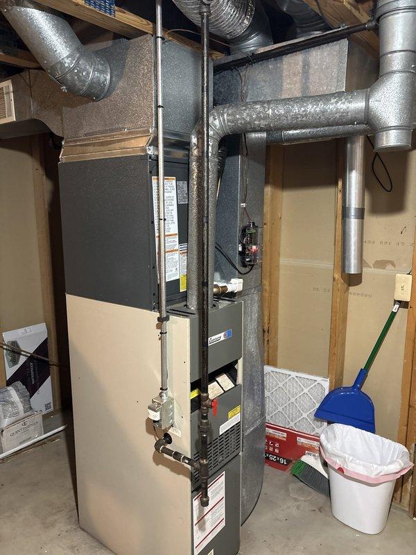 Completed full air conditioning system replacement including outdoor condensing unit and indoor furnace integration. Installed new condensing unit on existing concrete pad with proper electrical disconnect and conduit connections, positioned against brick exterior with adequate clearance for airflow and service access. Connected and secured all refrigerant lines, ductwork, and electrical components to manufacturer specifications, ensuring proper system operation and efficiency.