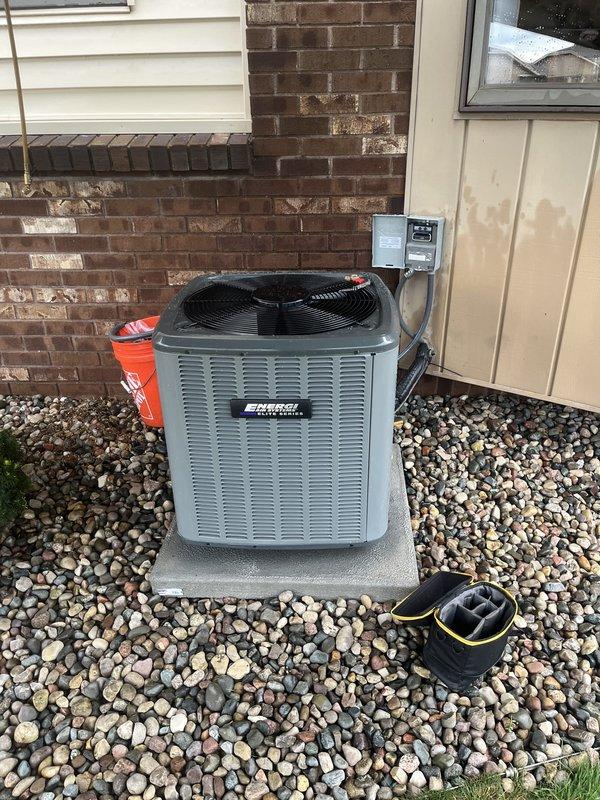 Completed full air conditioning system replacement including outdoor condensing unit and indoor furnace integration. Installed new condensing unit on existing concrete pad with proper electrical disconnect and conduit connections, positioned against brick exterior with adequate clearance for airflow and service access. Connected and secured all refrigerant lines, ductwork, and electrical components to manufacturer specifications, ensuring proper system operation and efficiency.