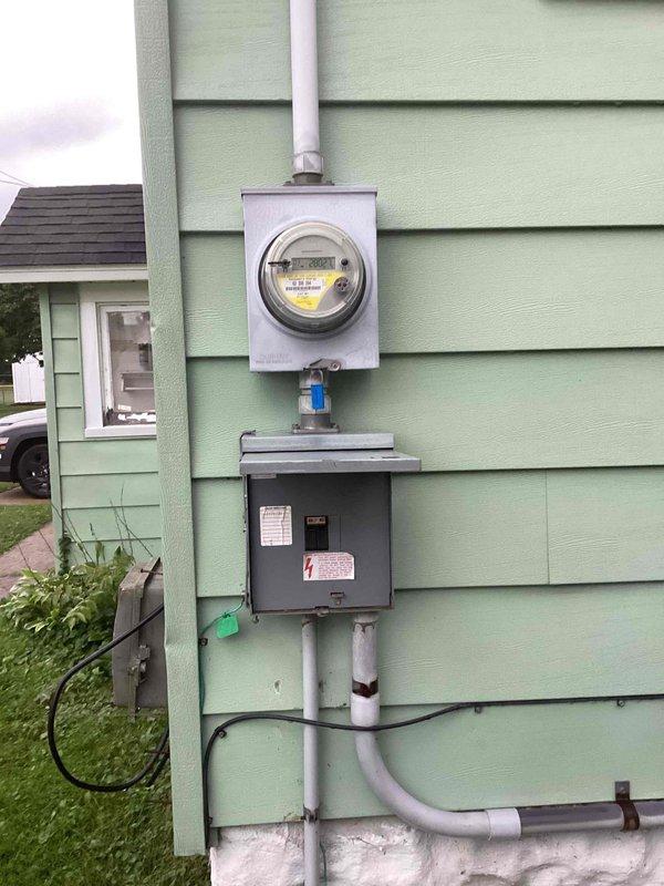 Conducted on-site assessment for mini split installation at residential property. Evaluated existing electrical infrastructure including main panel with dual-row breaker configuration and exterior meter assembly with disconnect box. Documented current electrical capacity and conduit routing to determine feasibility and requirements for new mini split system installation.
