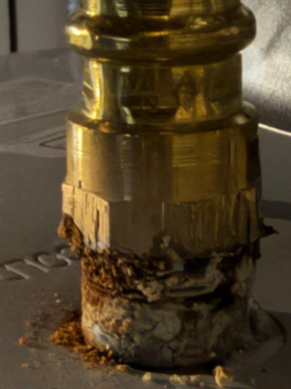 Responded to service call for water heater with corroding supply lines. Upon inspection, documented significant corrosion and mineral buildup on brass fittings at hot water connection point, with white and brown crusty deposits indicating active deterioration at dissimilar metal junctions. Photographed affected components showing advanced oxidation and mineral accumulation on threaded connections and mounting surfaces to document condition for replacement recommendations.