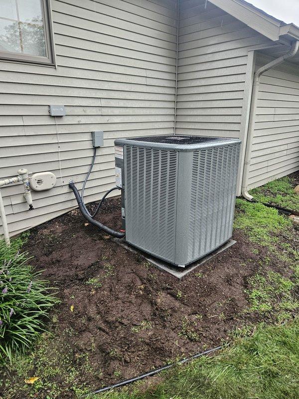 Completed full air conditioning system replacement at residential property. Installed new outdoor condensing unit on existing concrete pad with proper refrigerant line connections and electrical disconnect. Replaced indoor air handler in basement mechanical room with new unit featuring digital control panel. Verified all refrigerant lines, electrical connections, and ductwork transitions were properly secured and sealed. System tested and confirmed operational upon completion.
