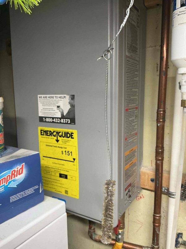 Performed comprehensive tankless water heater tune-up and flush service on unit approximately 5 years old. Completed descaling procedure using isolation valves and flushing equipment to remove mineral buildup from heat exchanger, cleaned inlet filter screen, verified proper operation of gas supply line and connections, and confirmed all plumbing components including copper piping and shut-off valves were functioning correctly.