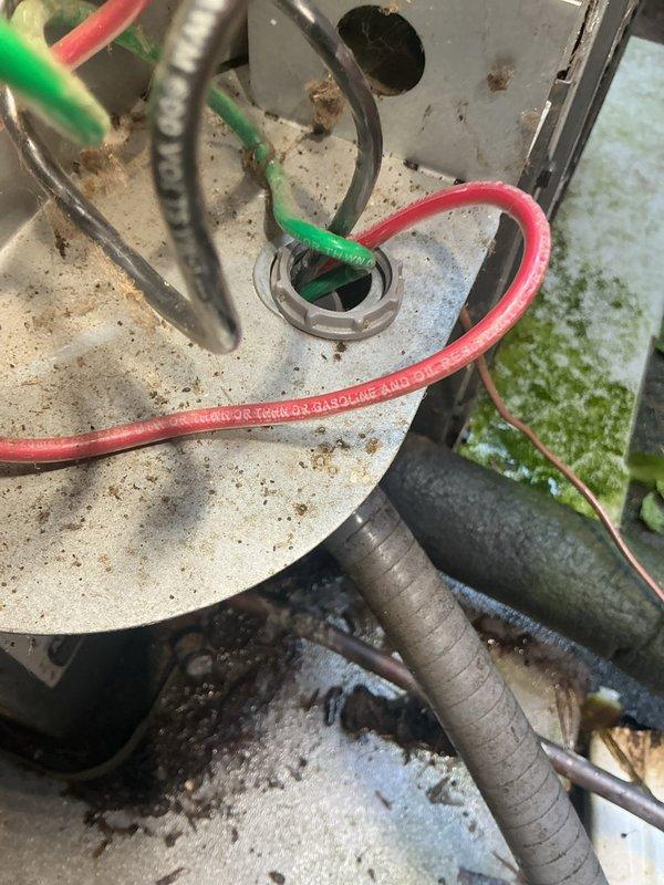 Responded to service call for air conditioning system repeatedly tripping circuit breaker at single-family residence. Unit is approximately 5 years old. Upon arrival, performed visual inspection of outdoor condensing unit and electrical components.

Inspection revealed significant accumulation of dirt, dust, and debris on condenser unit components and electrical connections. Examined refrigerant line connections and service ports, noting environmental contamination on exterior surfaces. Inspected electrical terminal block and wiring connections, observing heavy dust buildup and debris accumulation around wire terminations and connection points. Multiple conductor wires showed signs of age-related discoloration and environmental exposure.

Identified potential electrical issues related to compromised connections and contamination that could cause intermittent breaker trips. Terminal block showed signs of extended service with visible grime deposits around connection points. Black insula