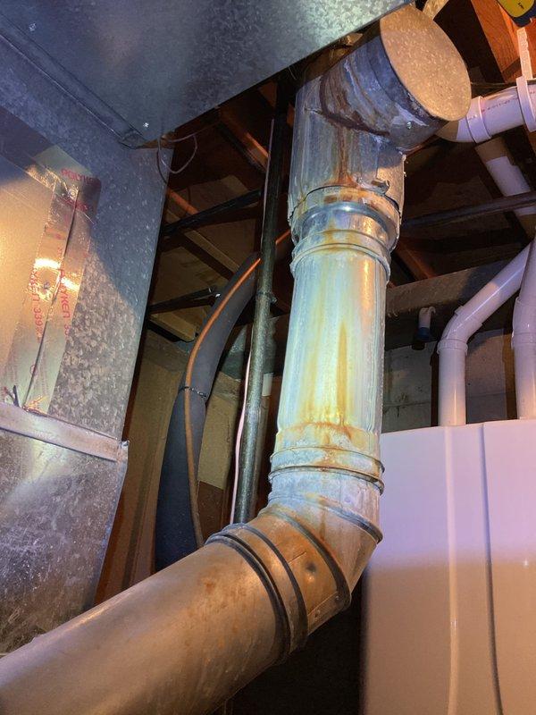 Completed comprehensive ASTU-AC Super Tune-up on dual EnergiAir systems (7-year warranties expiring 2028 and 2029). Performed full inspection of HVAC equipment including condensate drain pan, PVC drainage lines, and braided stainless steel flexible connections with secure hose clamps. Inspected vertical ductwork showing age-related oxidation and metal banding connections throughout basement installation. All systems tested and operational, with photo documentation captured for service records.