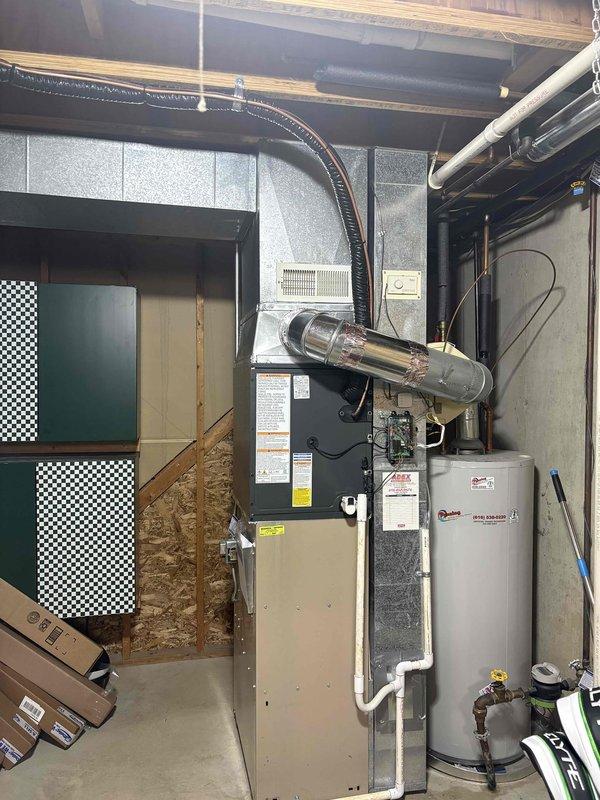 Completed full air conditioning system replacement at residential property. Installed new outdoor condenser unit on concrete pad with proper electrical disconnect and conduit connections. Unit positioned against exterior wall beneath window with appropriate clearances maintained. Indoor air handler installed in basement mechanical room, integrated with existing ductwork and ventilation systems using flexible duct connections. All electrical connections completed to code, system tested and verified operational upon completion.