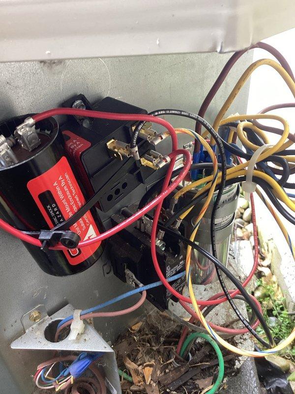 Responded to service call for residential cooling system not providing adequate cooling throughout home. Upon arrival, performed diagnostic testing on 10-year-old air conditioning unit using combustion analyzer to assess system performance and airflow. Inspected outdoor condenser unit electrical components, including contactor, relays, and associated wiring connections. Documented existing conditions showing accumulated debris around outdoor unit and signs of age on electrical components. Completed system evaluation and captured photographic documentation of electrical compartment and equipment testing for service records.