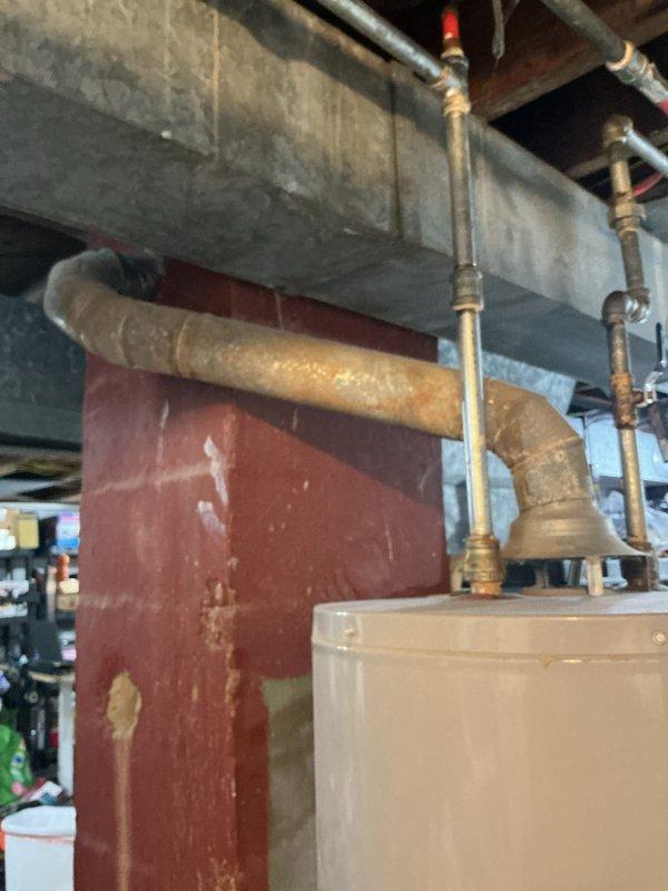 Responded to no hot water complaint and performed on-site assessment of existing water heater system in basement utility area. Documented current plumbing configuration including copper supply lines, brass connections, and existing water heater installation. Evaluated mechanical room infrastructure, pipe routing, and available workspace for potential replacement unit. Photographed existing equipment condition, pipe connections, support structures, and accessibility considerations to prepare comprehensive replacement estimate for new water heater installation.