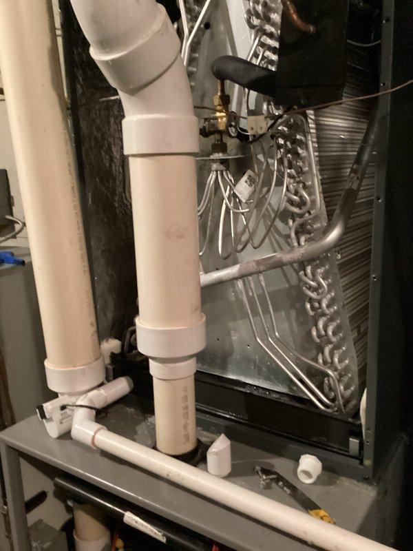 Completed annual cooling maintenance and system inspection. Examined evaporator coil assembly, condensate drain lines, and PVC piping connections in response to client concerns regarding excessive condensation around refrigerant lines. Inspected drain pan for proper drainage, verified all pipe joints and fittings for leaks, and tested system operation. Documented equipment condition with photos showing coil assembly, drain connections, and overall installation. Addressed client inquiry regarding water heater electric exhaust replacement options.