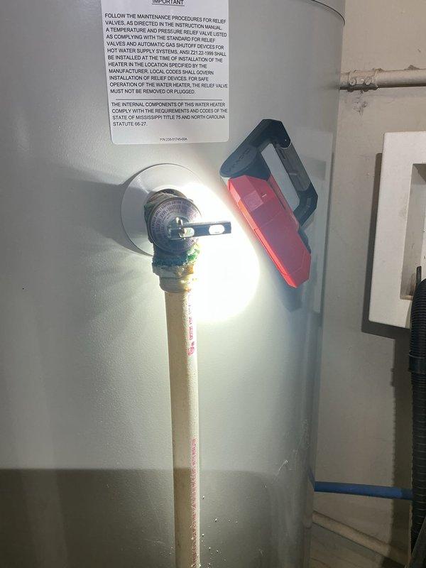 Responded to service call for water heater not producing hot water. Inspected Bradford white water heater unit and verified temperature and pressure relief valve operation, examined all plumbing connections including copper supply lines and red valve assembly at top of tank. Tested temperature control dial functionality and checked flue vent system for proper installation and secure mounting. Documented unit condition with photos showing valve connections, TPR valve with blue indicator, and overall installation including copper piping configuration and exhaust venting. All connections inspected and system evaluated for proper operation.