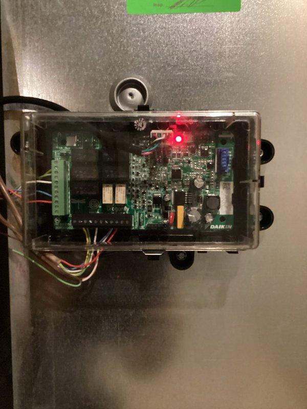 Responded to no cooling call on Daikin system. Upon arrival, inspected indoor unit control board and verified power supply with red LED indicator illuminated on main PCB. Documented control board configuration and wiring connections for customer records. System control board operating properly with all terminal connections secure and no visible signs of component failure or damage noted during inspection.