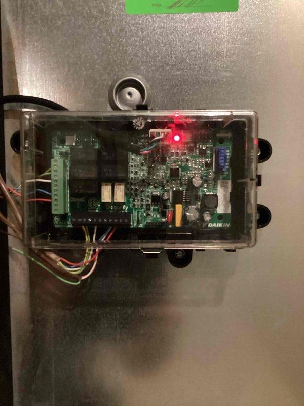 Responded to no cooling call on Daikin system. Upon arrival, inspected indoor unit control board and verified power supply with red LED indicator illuminated on main PCB. Documented control board configuration and wiring connections for customer records. System control board operating properly with all terminal connections secure and no visible signs of component failure or damage noted during inspection.