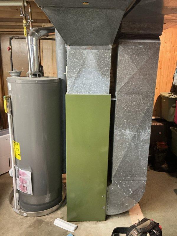 Responded to water leak concern on residential furnace system. Upon inspection, identified unit as an RGA120 gas furnace, approximately 20+ years old, manufactured by Rob Smith Arkansas. Unit was actively operational despite reported leak. Conducted thorough visual inspection of furnace cabinet, blower assembly, and associated ductwork. Examined water heater and surrounding plumbing connections in mechanical room to rule out external water sources. Inspected condensate drainage system and evaporator coil area for moisture accumulation. Documented equipment specifications including 45,000 BTU/HR minimum input rating and blower motor specifications. Photographed furnace identification label showing model number and technical data for warranty processing. Performed furnace tune-up as requested, including inspection of burner assembly, heat exchanger, blower motor operation, and gas pressure readings. Verified proper airflow through ductwork system. No active water leak observed during ser