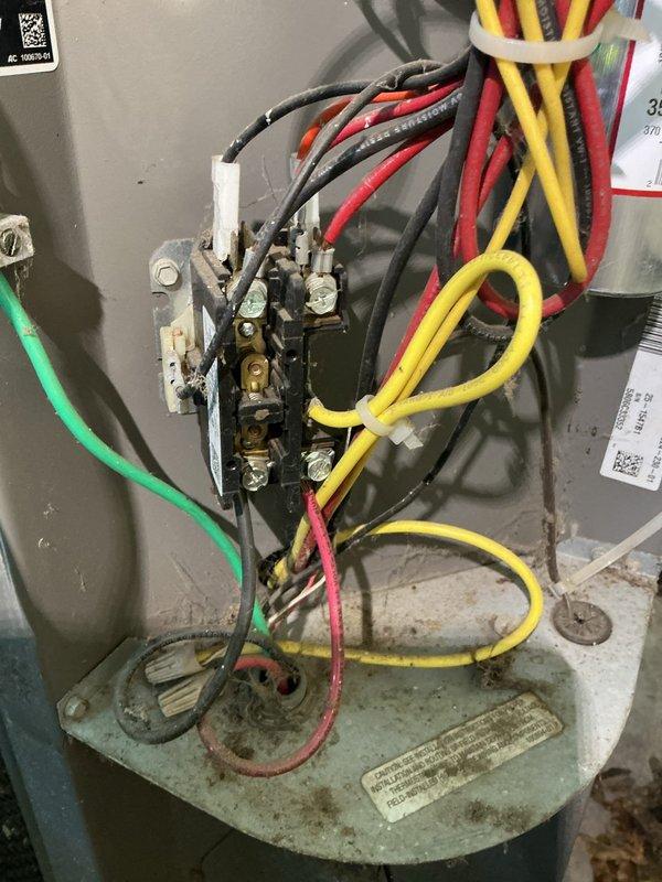 Responded to a no cooling call and performed diagnostic inspection of the HVAC system. Upon examination of the electrical compartment and exterior junction box, found significant accumulation of dirt, dust, and debris throughout the unit indicating lack of recent maintenance. Inspected terminal block connections, contactor assembly, and all electrical wiring including power conductors and control wiring. All wire connections at terminals were verified secure, though visible corrosion and oxidation were noted on metal components consistent with age and environmental exposure. The exterior disconnect box showed weathered conditions with cobwebs present around terminal connections. Documented current condition of equipment with photographs for service records. Unit wiring configuration was intact with proper color-coded conductors and secure zip-tie bundling where appropriate.