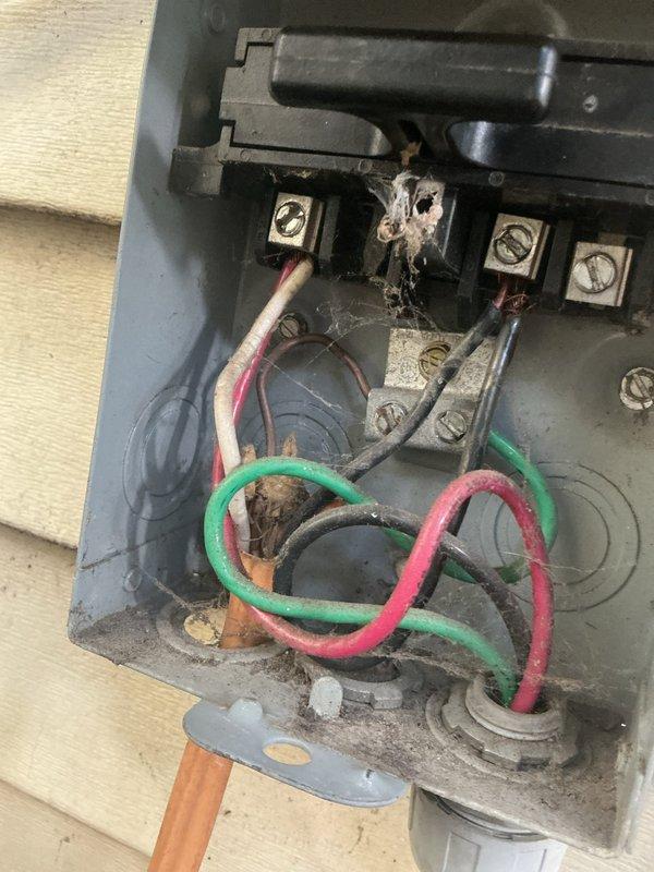Responded to a no cooling call and performed diagnostic inspection of the HVAC system. Upon examination of the electrical compartment and exterior junction box, found significant accumulation of dirt, dust, and debris throughout the unit indicating lack of recent maintenance. Inspected terminal block connections, contactor assembly, and all electrical wiring including power conductors and control wiring. All wire connections at terminals were verified secure, though visible corrosion and oxidation were noted on metal components consistent with age and environmental exposure. The exterior disconnect box showed weathered conditions with cobwebs present around terminal connections. Documented current condition of equipment with photographs for service records. Unit wiring configuration was intact with proper color-coded conductors and secure zip-tie bundling where appropriate.