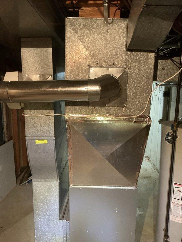 Responded to no-start air conditioning complaint where outdoor condenser unit was buzzing but compressor not running. Upon inspection, identified 20+ year old system with failed compressor and associated electrical components. Documented existing basement HVAC installation including furnace, ductwork, and mechanical room configuration, as well as outdoor condenser unit location and condition. Provided estimate for compressor replacement or full system replacement options given age of equipment.