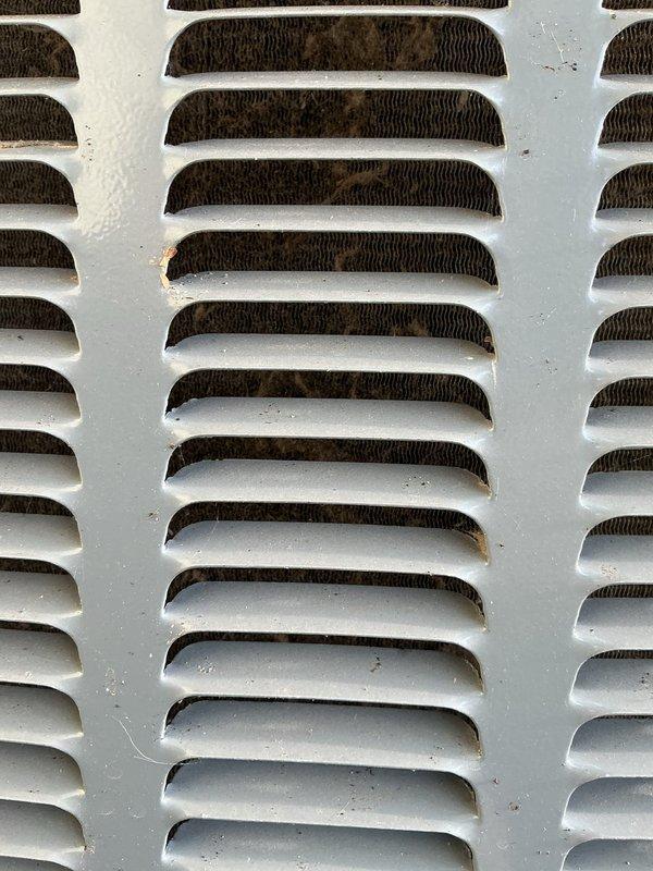 Completed annual cooling system maintenance and inspection. Outdoor condenser unit showed significant debris accumulation on louvers and coil fins with visible rust spotting on metal surfaces, which was cleaned and addressed. Inspected indoor condensate pump system in drain pan, verified proper operation and drainage through PVC discharge lines. All components functioning within normal parameters upon completion of tune-up service.