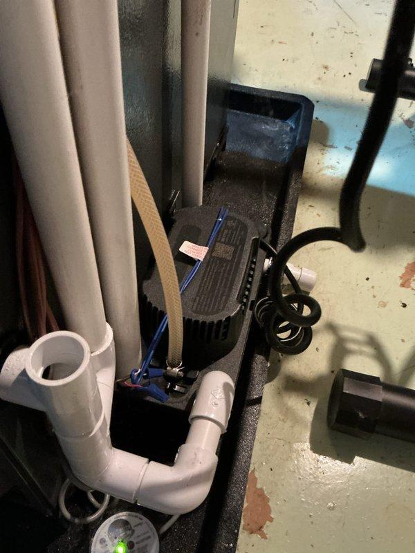 Completed annual cooling system maintenance and inspection. Outdoor condenser unit showed significant debris accumulation on louvers and coil fins with visible rust spotting on metal surfaces, which was cleaned and addressed. Inspected indoor condensate pump system in drain pan, verified proper operation and drainage through PVC discharge lines. All components functioning within normal parameters upon completion of tune-up service.
