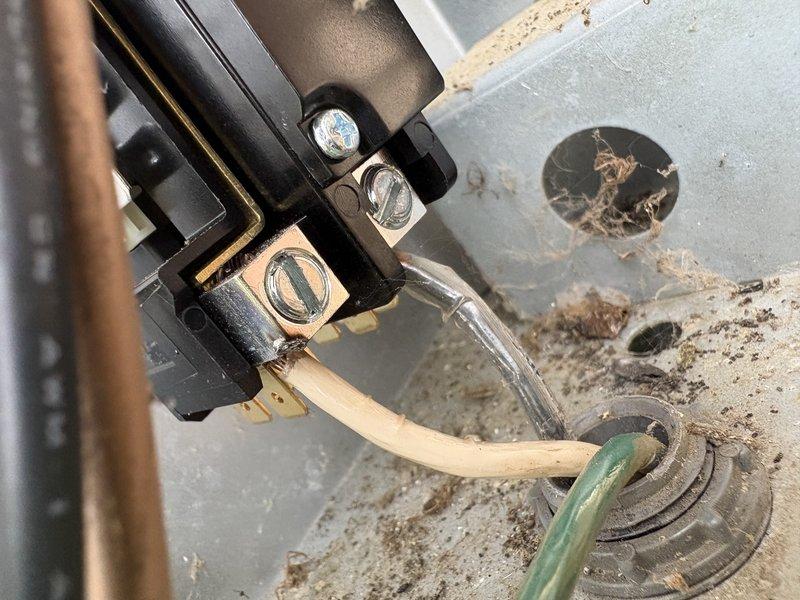 # Service Completed

Responded to no heat/no cool call on 11-year-old EnergiAir heat pump system affecting entire residence. Customer reported power to unit but no airflow, with slight humming noise when fan engaged.

Upon arrival, conducted system evaluation of outdoor heat pump unit and electrical components. Inspection revealed corroded outdoor disconnect and compromised electrical connections at unit terminals. Photos documented extensive rust on exterior valve components and deteriorated wiring connections at terminal block.

Performed the following repairs:
- Inspected and tested electrical connections at outdoor unit
- Evaluated compressor operation and fan motor functionality
- Checked refrigerant line connections and insulation integrity
- Assessed outdoor disconnect condition and grounding connections
- Verified proper voltage supply to unit

Found faulty electrical connections preventing proper system operation. Cleaned terminal connections, secured ground wire, and restored
