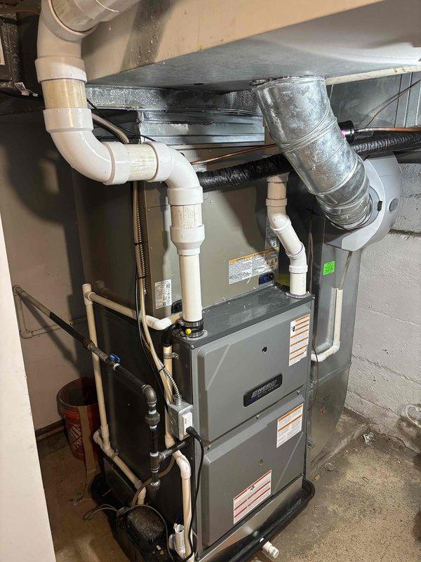Completed full HVAC system replacement including outdoor condenser unit and indoor furnace. Installed new Carrier brand air conditioning condenser on existing concrete pad with proper refrigerant line connections and electrical hookup. Replaced furnace unit in basement utility area with complete ductwork integration, including metal supply and return ducts. Installed new PVC condensate drain lines with proper pitch and trap configuration. Connected copper refrigerant lines between outdoor condenser and indoor evaporator coil. Verified all electrical connections at meter base and confirmed proper voltage supply to equipment. Tested system operation including airflow, refrigerant charge, and thermostat communication. All components functioning within manufacturer specifications upon completion.