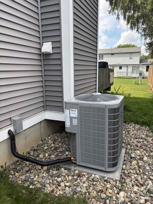 Completed full HVAC system replacement including outdoor Daikin condensing unit installed on concrete pad with proper drainage and river rock landscaping, and indoor Carrier humidifier integrated with existing furnace/air handler system in basement utility area. All equipment properly mounted, connected, and activated with financing processed through approved lender.
