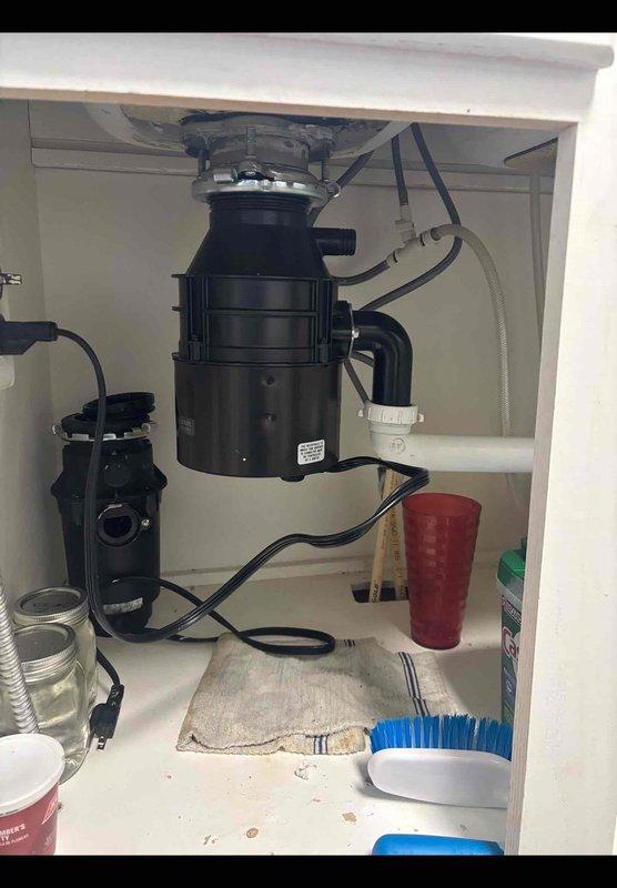 Responded to disposal replacement call where homeowner had unsuccessfully attempted installation. Removed old disposal unit and mounting assembly from under kitchen sink. Successfully installed replacement disposal unit, connected drain lines and dishwasher discharge hose, verified proper mounting and seal integrity, tested unit operation and checked for leaks. System functioning properly upon completion.