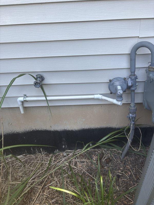 Responded to inspector correction regarding NFPA code violation for insufficient clearance between gas regulator vent and condenser unit. Measured and documented existing spacing between fixtures, confirming compliance with required 3-foot minimum clearance specification. Photographed gas meter assembly, piping configuration, and outdoor fixtures to provide verification of corrected installation for code compliance approval.