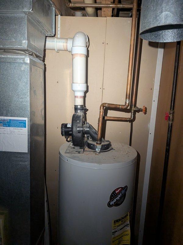 Responded to service call for unfamiliar noise coming from 22-year-old Amana furnace that had not been serviced in approximately one year. Upon arrival, performed comprehensive system inspection and diagnostic evaluation of the heating unit. Conducted visual examination of all accessible components including blower assembly, heat exchanger, burner compartment, and motor bearings to identify source of abnormal sound. Checked electrical connections, gas valve operation, and flame sensor condition. Inspected ductwork connections and verified proper airflow throughout the system. Evaluated inducer motor and wheel for debris accumulation or wear that could cause unusual operational sounds. Tested system through complete heating cycle while monitoring for noise patterns and irregularities. Documented current condition of aging equipment with photographic evidence of installation and surrounding utility area. System found to be operational despite age-related wear concerns typical of units ex
