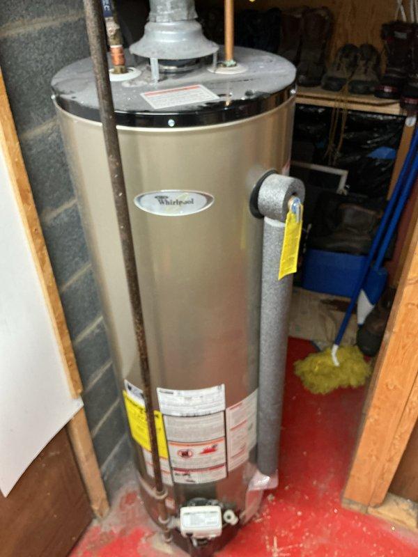Responded to service call for water heater that would not stay lit or relight, resulting in no hot water. Upon review of the 10-year-old Whirlpool unit installed in basement utility area, documented existing conditions through photographic documentation showing the complete water heater assembly, piping connections, and installation environment. Customer declined on-site diagnostic visit at this time and requested estimate for repair versus replacement options. Appointment cancelled per customer request with instructions to contact office if service call is desired in the future.