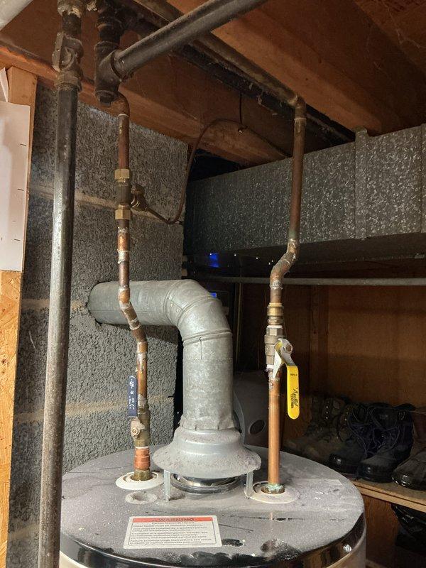 Responded to service call for water heater that would not stay lit or relight, resulting in no hot water. Upon review of the 10-year-old Whirlpool unit installed in basement utility area, documented existing conditions through photographic documentation showing the complete water heater assembly, piping connections, and installation environment. Customer declined on-site diagnostic visit at this time and requested estimate for repair versus replacement options. Appointment cancelled per customer request with instructions to contact office if service call is desired in the future.