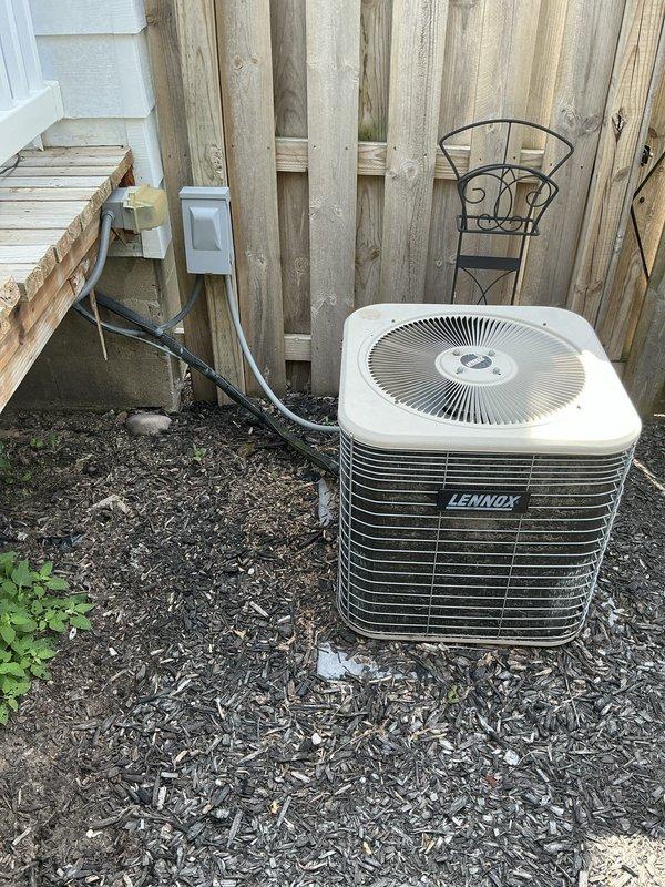 Completed comprehensive estimate for furnace and air conditioning system replacement with evaluation of equipment relocation requirements. Assessed existing Lennox condensing unit positioned on exterior mulch bed adjacent to wooden deck structure, documented current refrigerant line routing and electrical connections, and evaluated crawlspace foundation area where furnace repositioning is proposed. Identified potential need for plumbing coordination related to separate office work requirements.