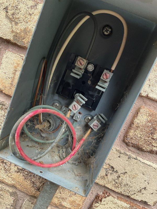 Responded to service call for 20-year-old air conditioning system with suspected low refrigerant levels. Performed comprehensive system inspection including visual assessment of outdoor unit components, electrical disconnect box, and refrigerant line connections. Documented existing equipment condition showing age-appropriate wear, outdoor environmental exposure, and corrosion at electrical connection points. Evaluated system to determine whether refrigerant recharge would be cost-effective solution given unit age and overall condition, providing customer with professional recommendations for repair versus replacement considerations.