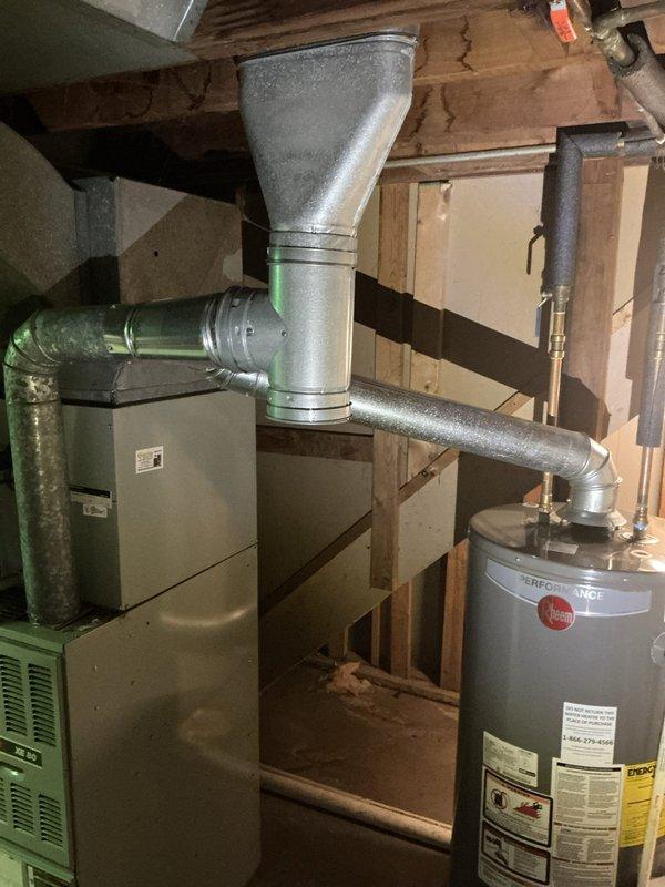 Conducted on-site evaluation for complete HVAC system replacement including 16-year-old air conditioning unit and furnace experiencing operational noise issues upon startup. Assessed existing Trane XE 80 furnace and companion AC system in basement mechanical room, documented equipment specifications, ductwork configuration, and electrical connections. Photographed current installation layout including main supply plenum, refrigerant lines, and existing duct transitions to provide accurate replacement system specifications and installation requirements for comprehensive furnace and air conditioner upgrade estimate.