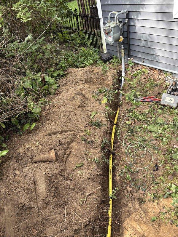 Successfully installed a 20KW Kohler standby generator with 100A service upgrade at residential property. Coordinated utility disconnect/reconnect with Great Lakes Energy for safe electrical work completion. Excavated trench alongside house foundation to proper depth specifications for underground gas line and electrical conduit installation, as verified by measurement documentation. Completed service upgrade and generator mounting on exterior wall with gray vinyl siding. Obtained electrical permit PE26-0083 and mechanical permit PM26-0096 prior to installation. Scheduled and passed gas pressure test and electrical inspections. Power disconnection occurred in morning hours with restoration completed same afternoon. All work performed to code requirements with proper permitting and inspection protocols followed throughout installation process.