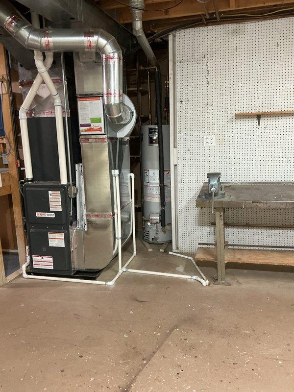 Provided estimate for replacement of existing 40-gallon gas-fired Bradford White water heater located in basement utility area. Assessed current installation including copper supply piping, foam pipe insulation, shutoff valves, and connections to existing HVAC system, documenting equipment specifications and surrounding workspace conditions for accurate replacement proposal.