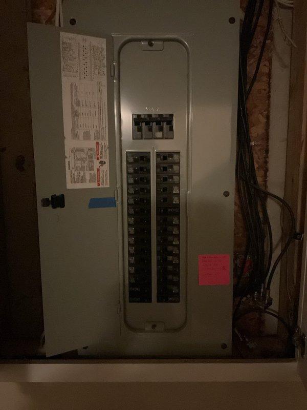 Assessed residential kitchen for electric range conversion from existing gas appliance. Evaluated electrical panel capacity and determined routing requirements for new dedicated 240V circuit installation from main panel to kitchen range location. Documented current gas range setup, available panel space with existing breaker configuration, and wire path through unfinished basement area to support future electric range installation.