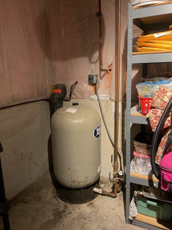 Responded to report of active leak at pressure tank system. Upon arrival, conducted thorough inspection of the water pressure tank, bladder assembly, and associated pressure pump components. Examined all visible plumbing connections, fittings, and copper piping for signs of moisture, corrosion, or active leakage. Tested pressure gauge operation and verified system pressure readings. Inspected tank exterior for integrity issues and checked bladder function through standard diagnostic procedures. Evaluated pump operation and cycling performance. Documented equipment condition through photographic evidence showing tank installation, piping configuration, and surrounding utility area. Identified source of reported leak and provided assessment of overall system condition.